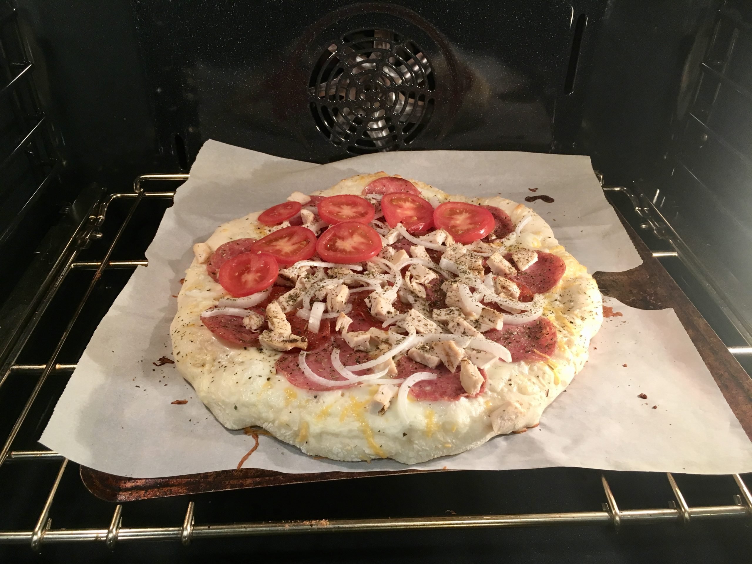 homemade pizza baking in the oven