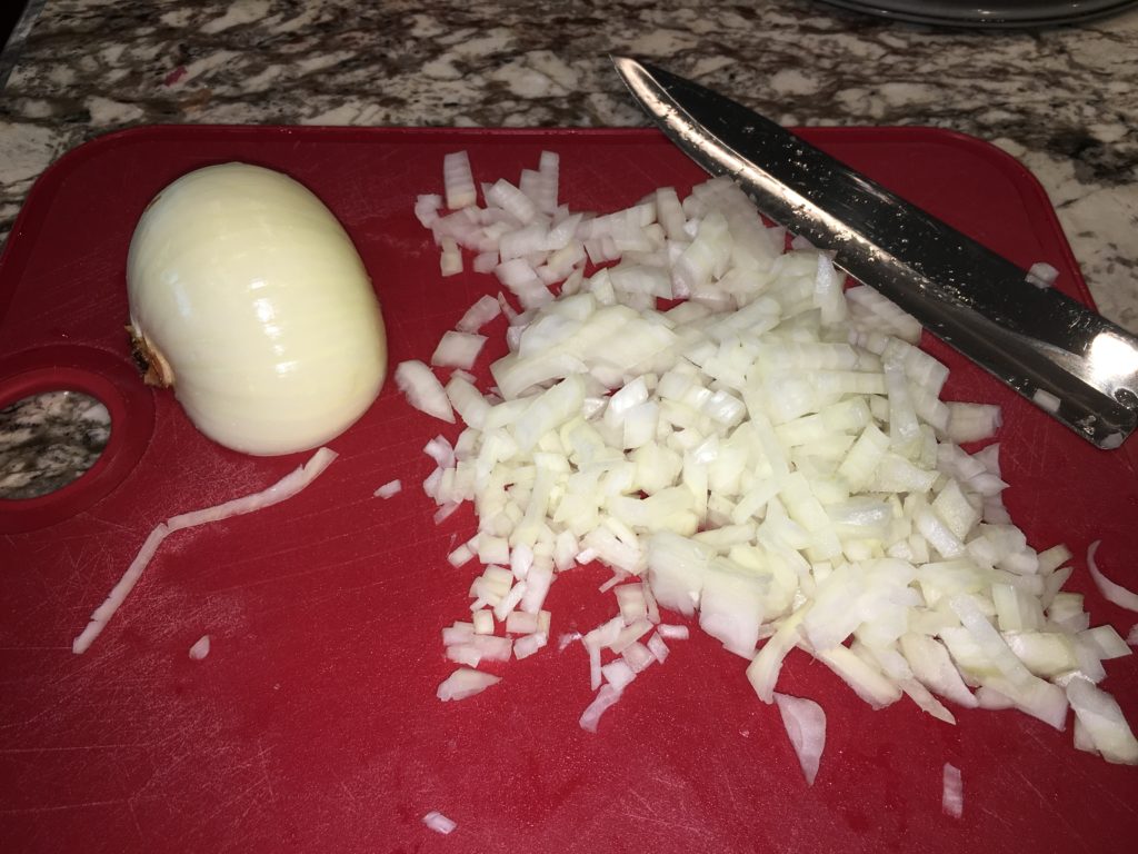 diced onions on a chopping board