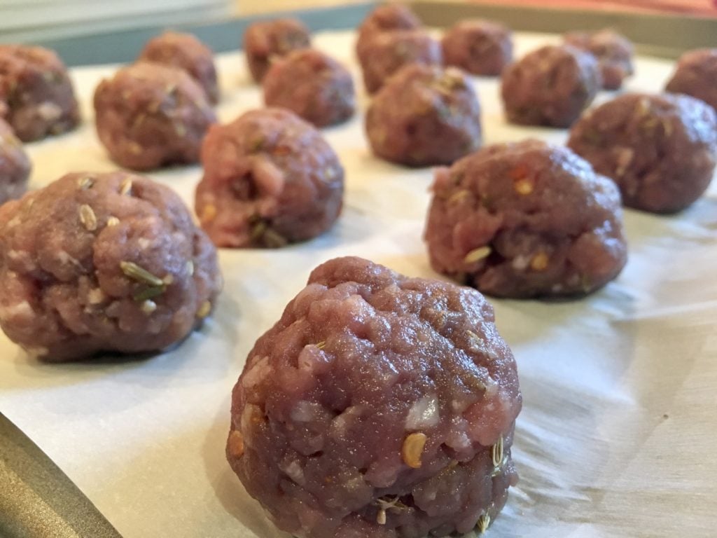 placing the meatballs on a cookie sheet and before returning to the fridge