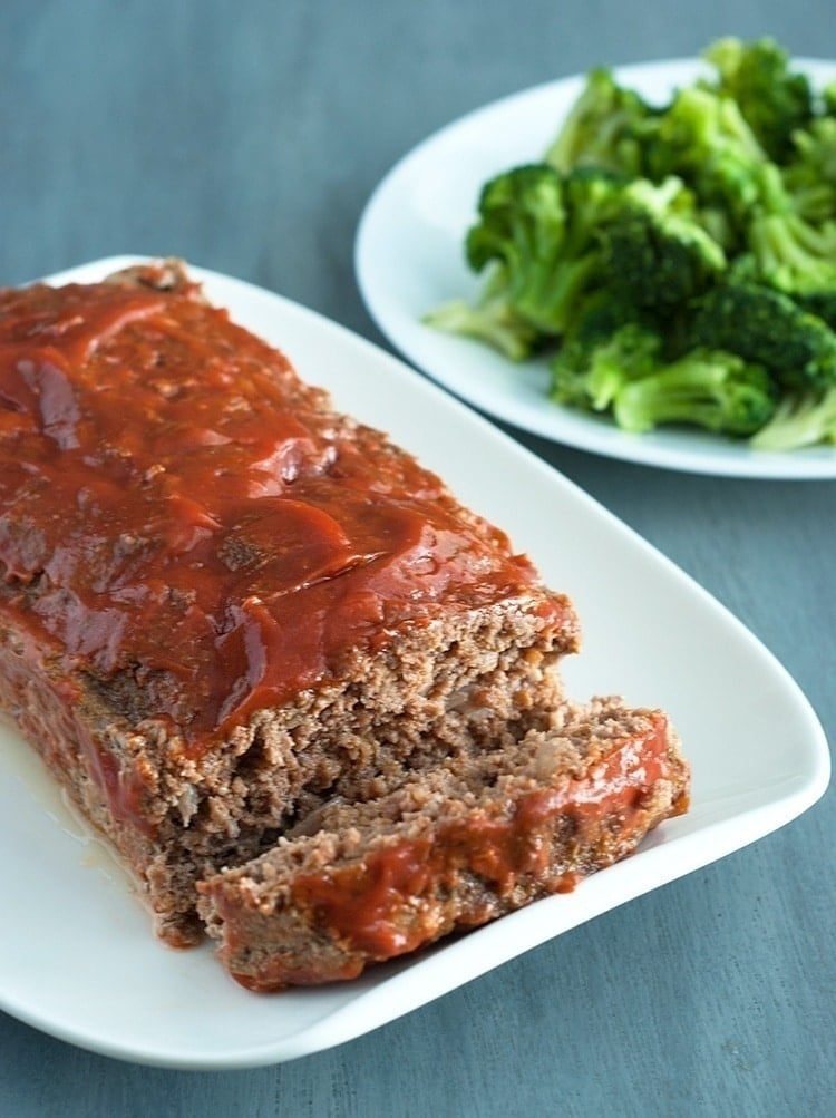 meatloaf on a plate with a veggies on the side