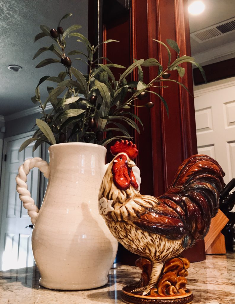 a planted vase and a rooster figurine.