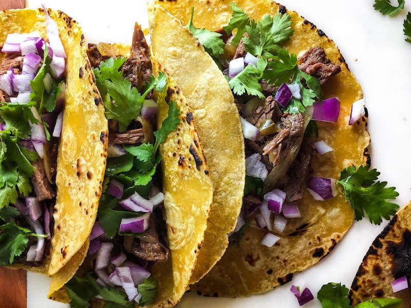 Shredded beef tacos on a plate