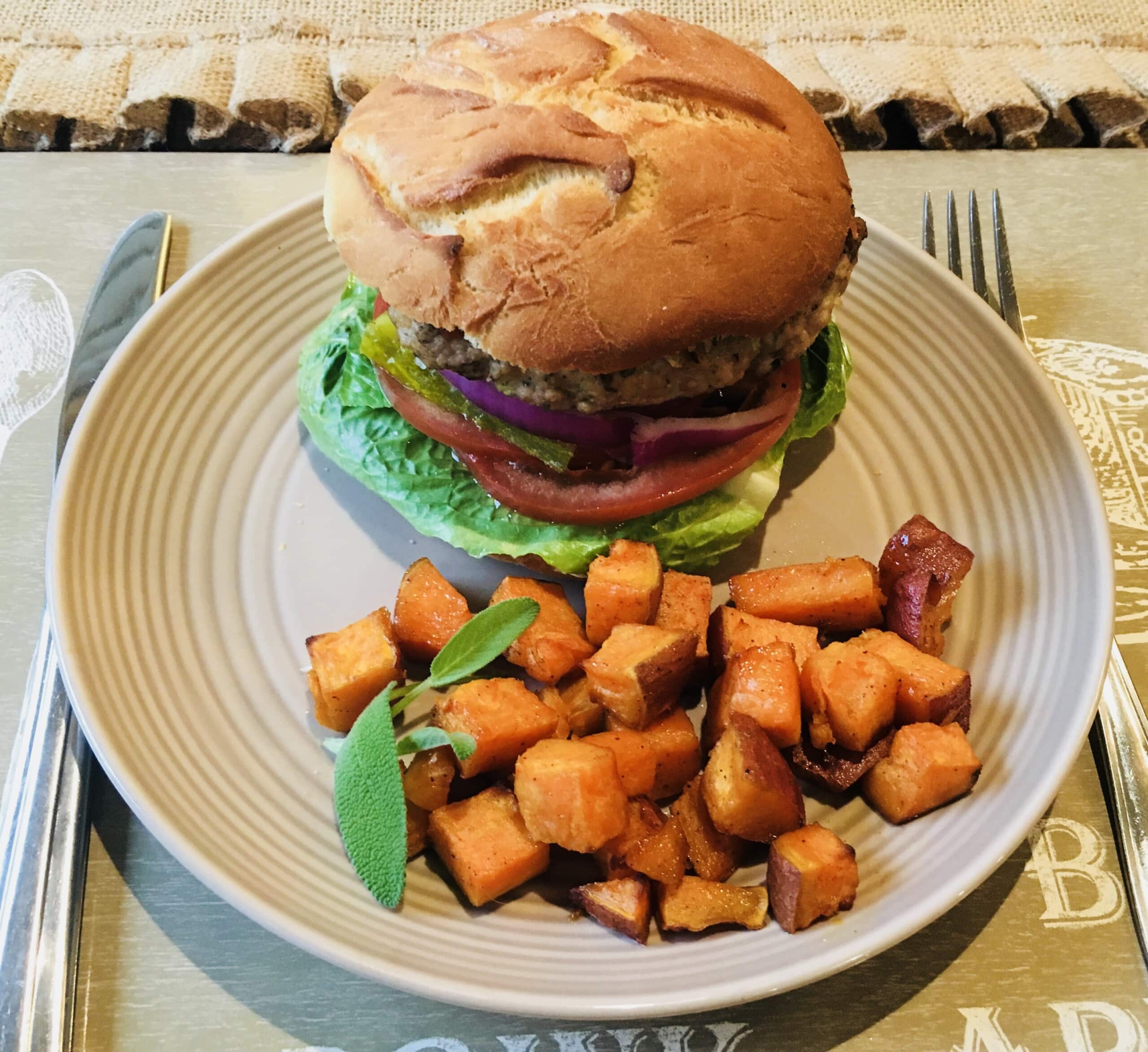 a plate of turkey burger with sweet potato fries
