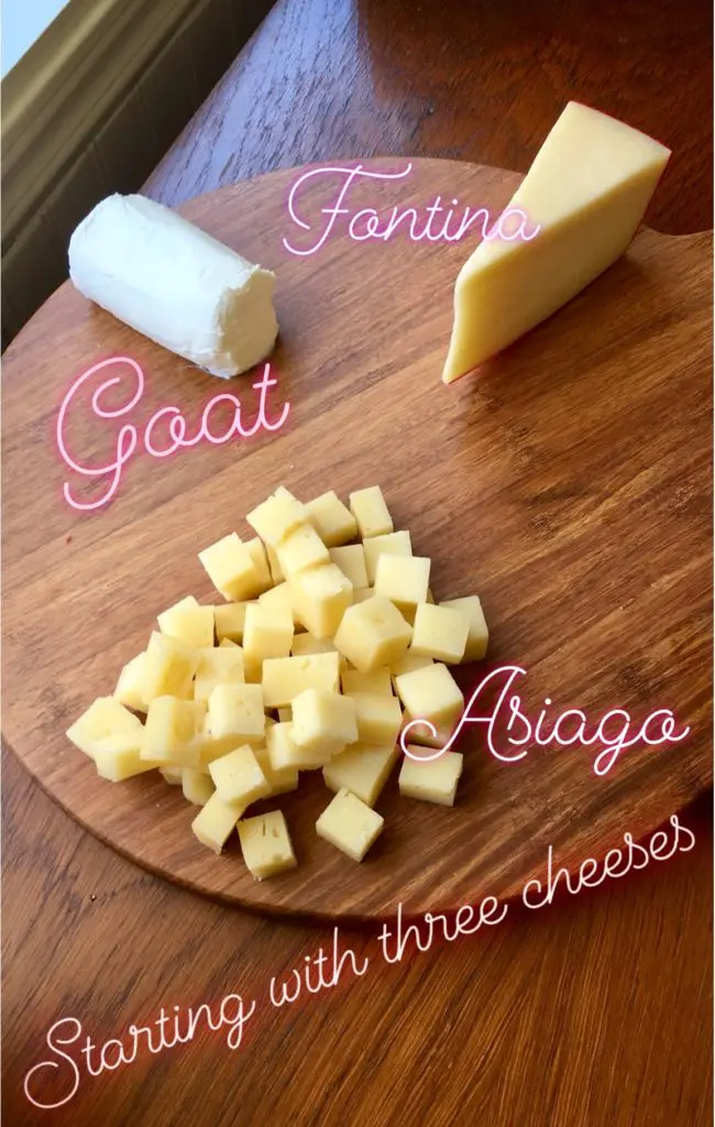 Charcuterie ingredients for cheese and charcuterie board - Goat/brie cheese, Asiago, Fontina