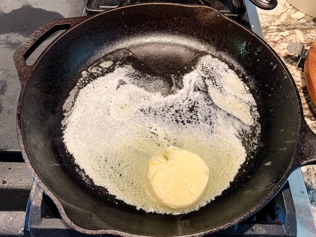 butter melting in a cast iron skillet