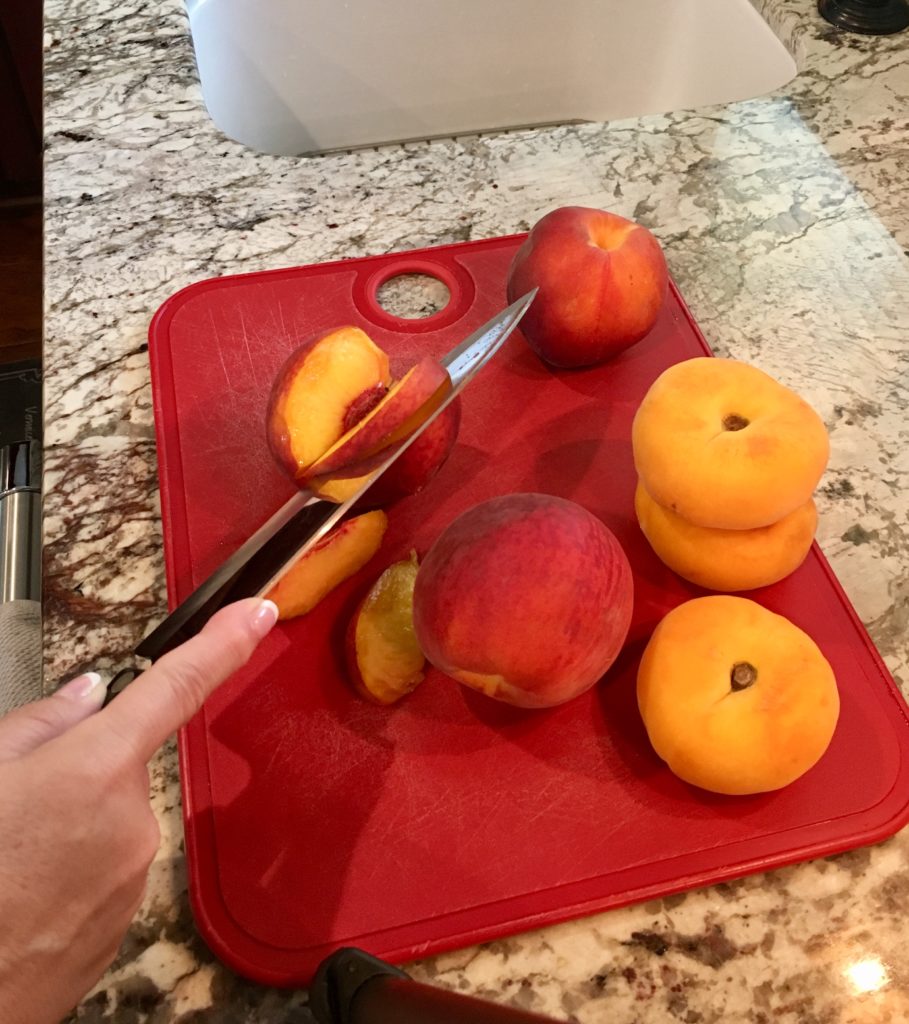 sliced fresh peach on a chopping board
