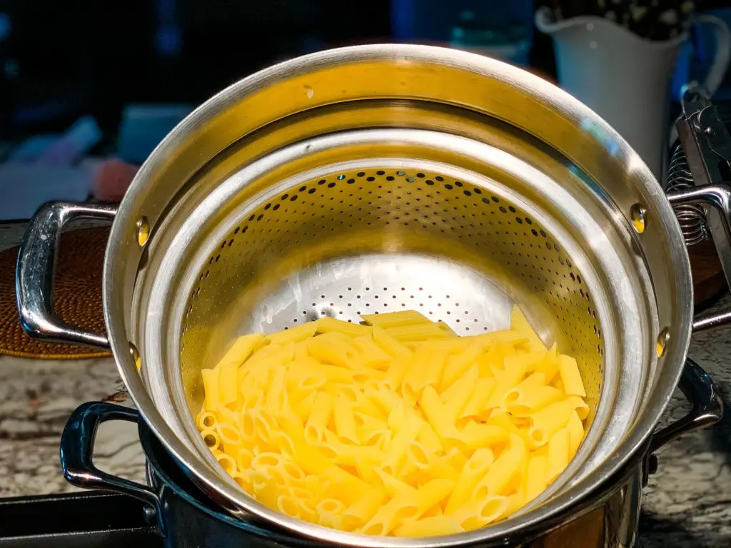 draining the pasta on a strainer