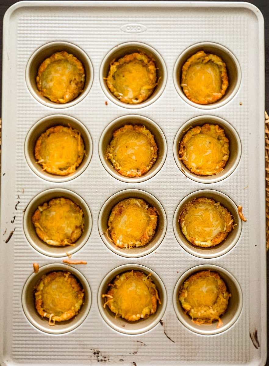 Muffin tin tots with melted cheese.