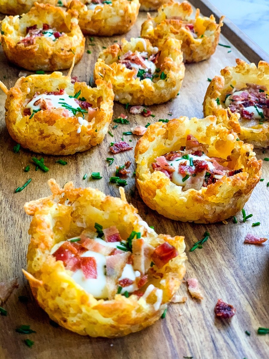 Smashed tater tots topped with bacon and sour cream.