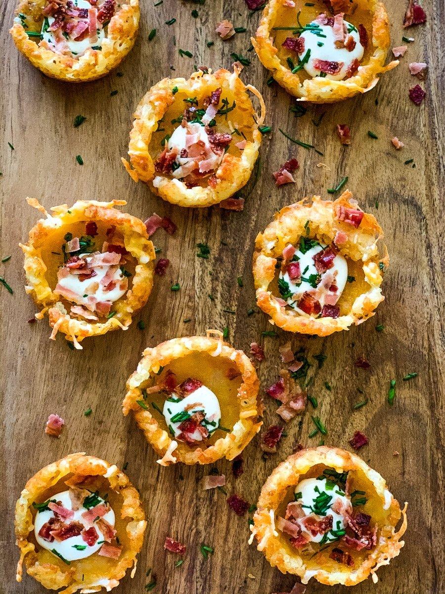 Tater tot appetizers on a wooden serving board.