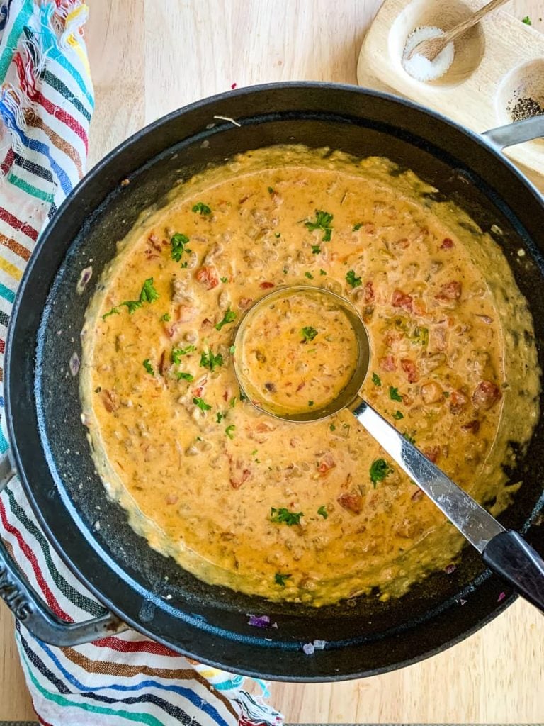 overhead: Ladle in a pot of keto cheeseburger soup.