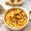 round casserole dish with loaded potatoes.