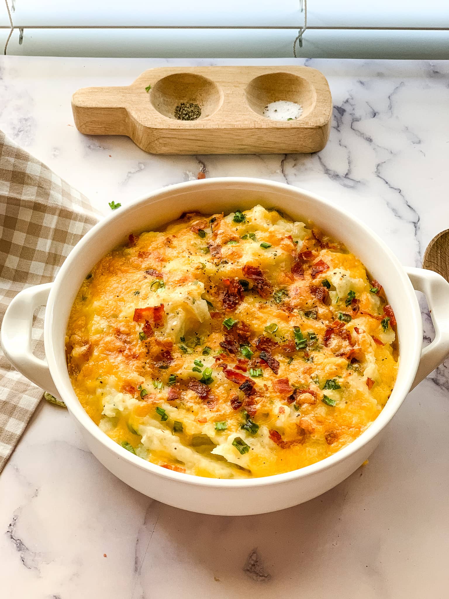 round casserole dish with loaded potatoes.
