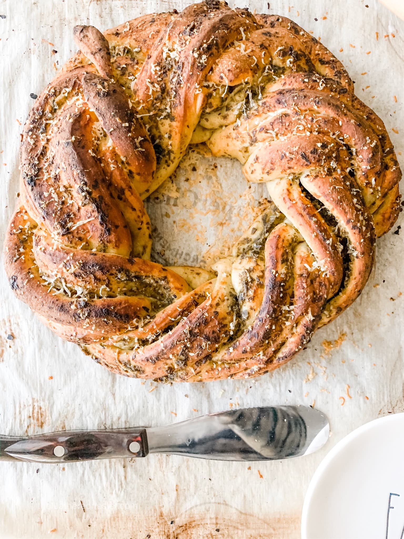 Wreath of twisted bread with Parmesan and pesto sauce baked into it.
