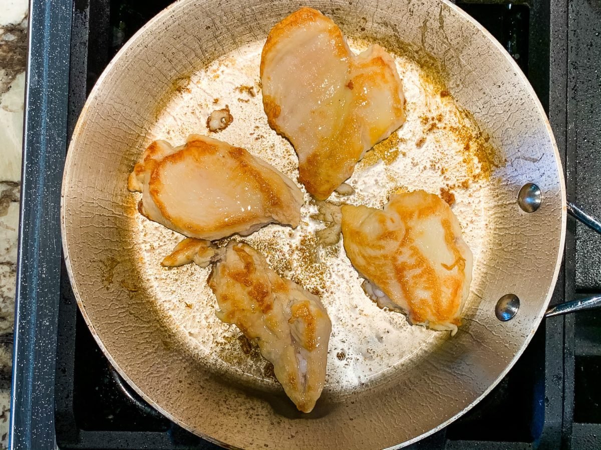 pan searing poultry cutlets in a large skillet.