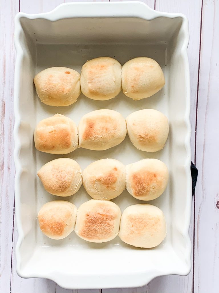 Baked Parker House rolls in a baking dish.