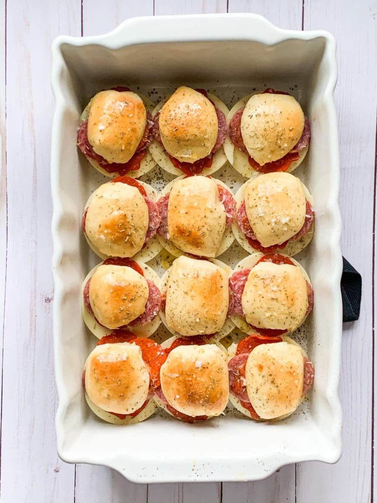 Baked Italian sliders in a white baking dish.