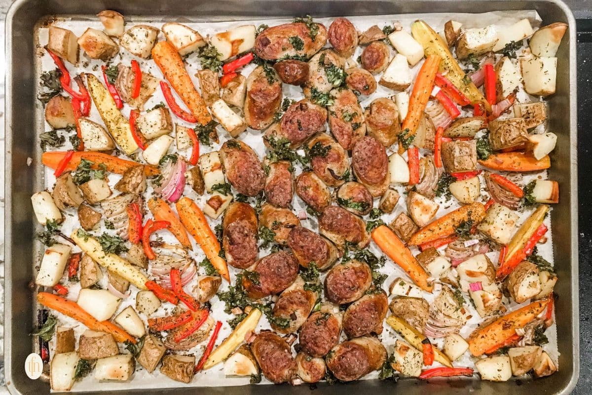 A sheet pan of sausage and mixed vegetables.