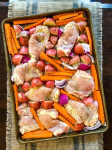 chicken thighs with veggies on a sheet pan
