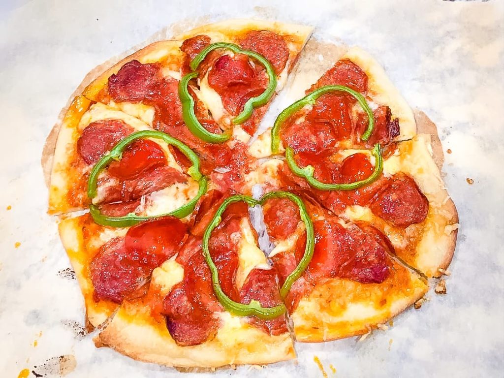 pizza crust from scratch topped with pepperoni and bell pepper