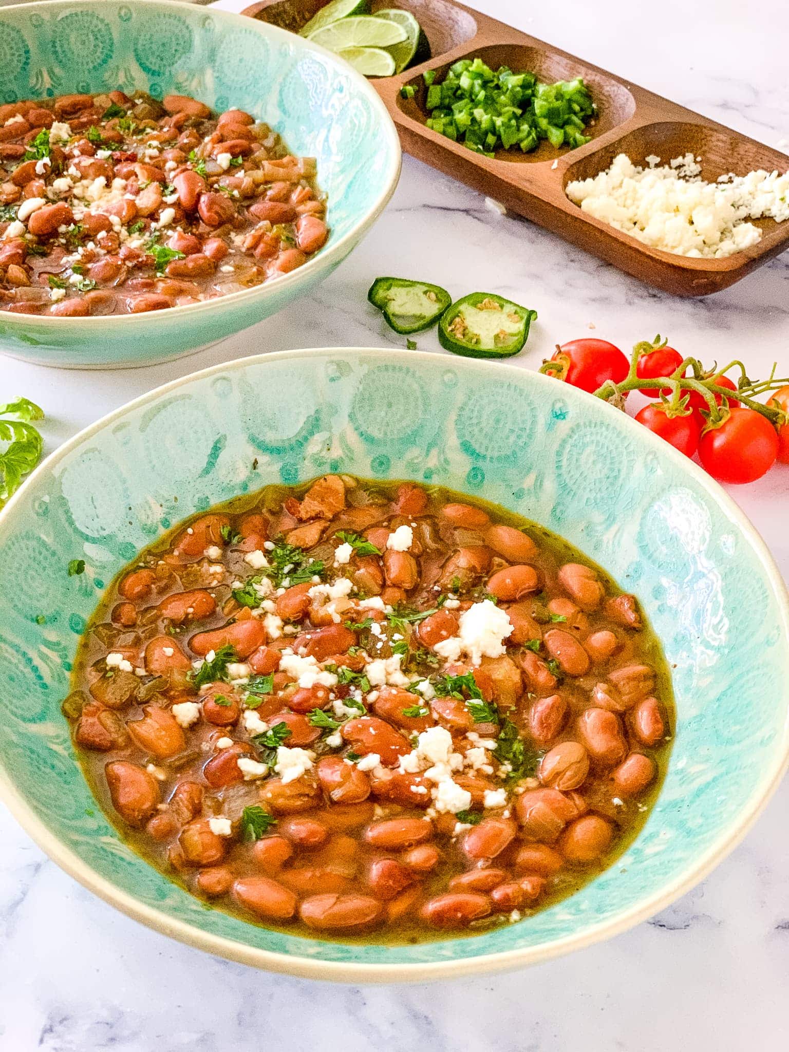 pinto beans in bowls with toppings.