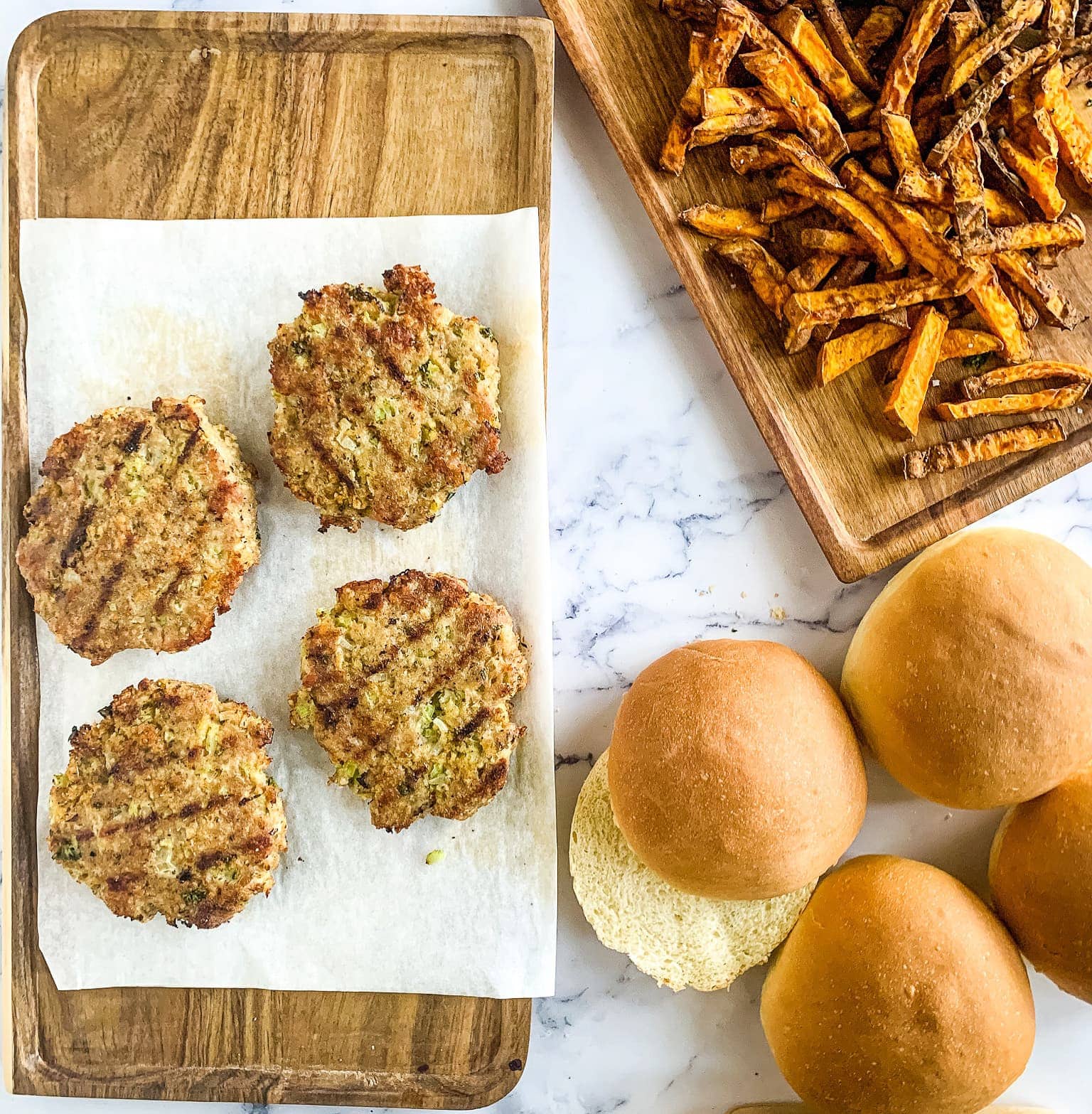 grilled turkey burgers with buns and potato fried at the side.