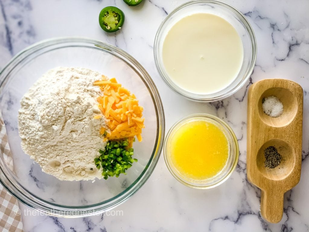 bowls of ingredients on a counter for jalapeno cheddar biscuit recipe