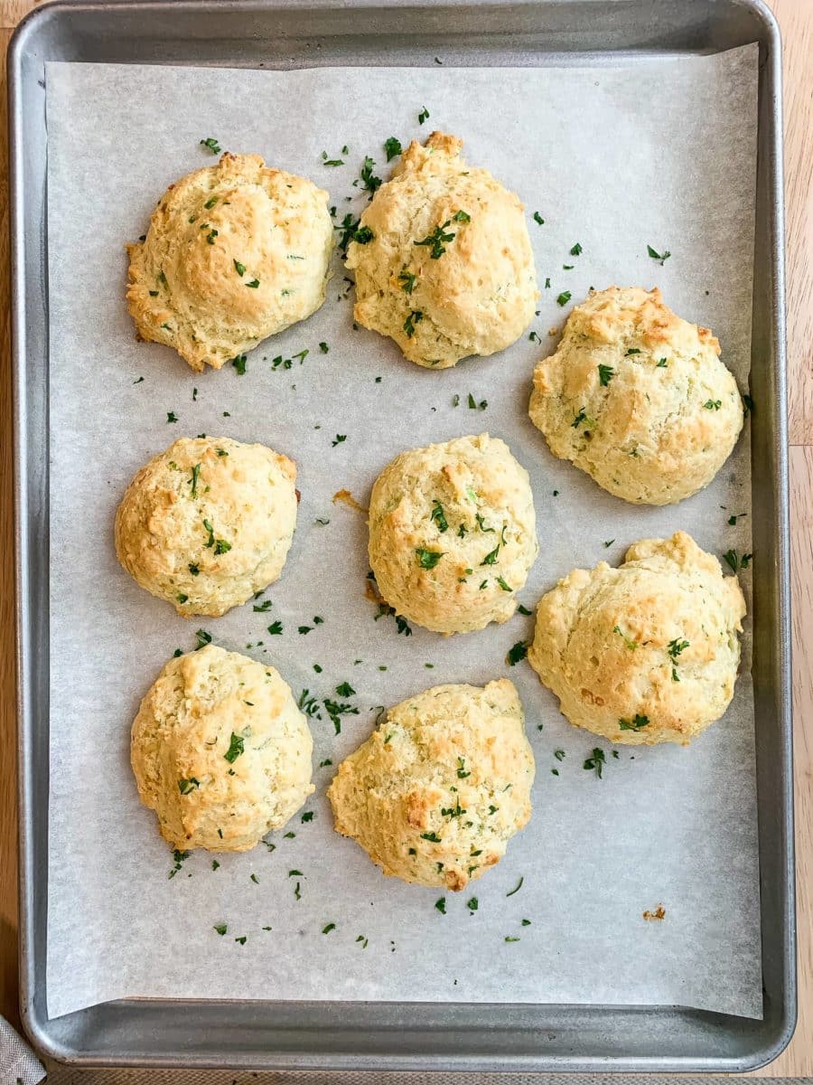 Spicy cheddar drop biscuits on a baking sheet.