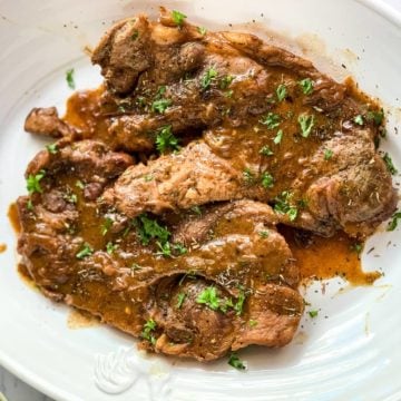 Pork Chops with gravy on a serving platter.