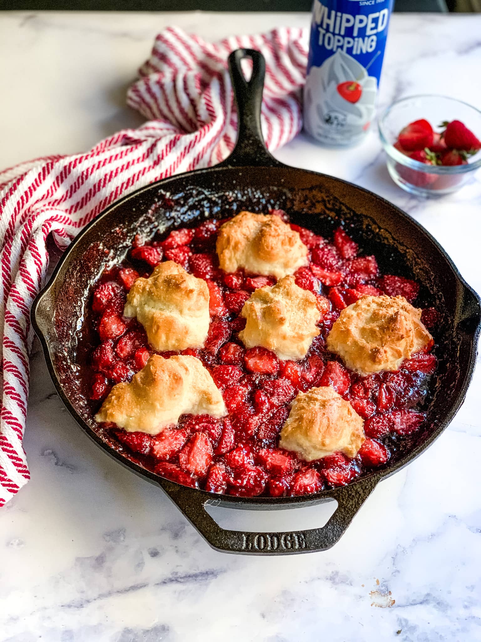 Strawberry cobbler in a cast iron skillet.