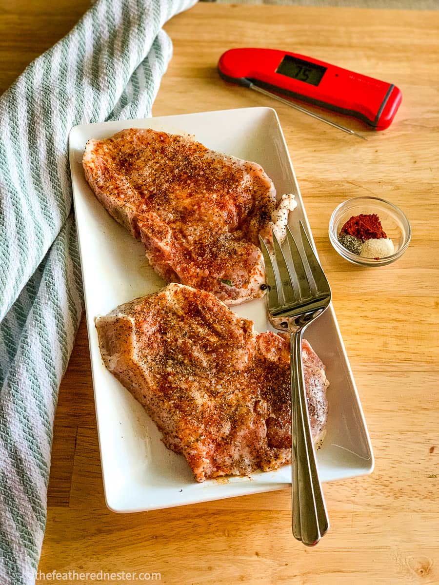 A platter of seasoned pork chops.