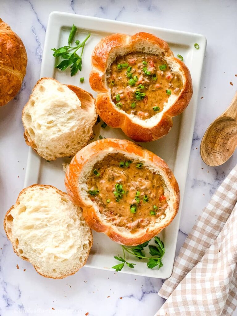 a serving platter containing bread bowl filled with cheeseburger soup recipe