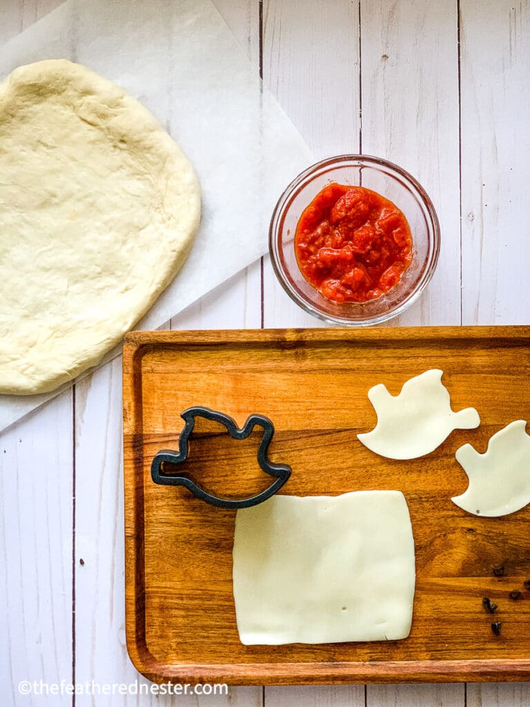 mozzarella cheese, pizza crust, and sauce - halloween mini pizza supplies for halloween food ideas for kids 