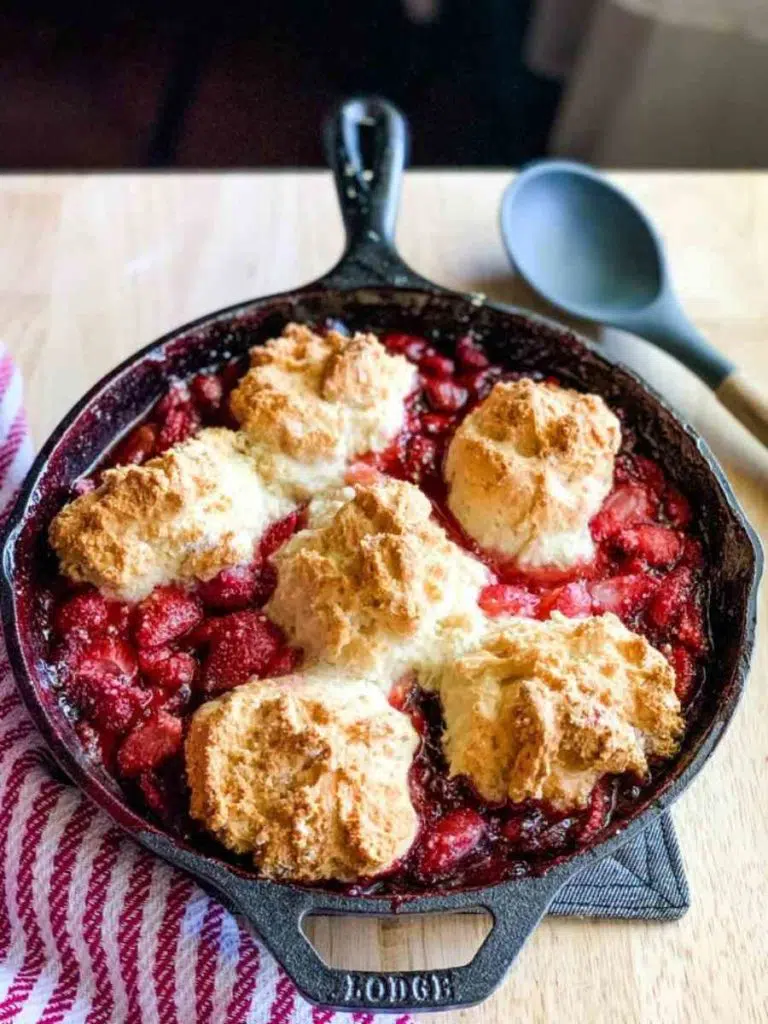 Bisquick strawberry cobbler in a cast iron skillet.