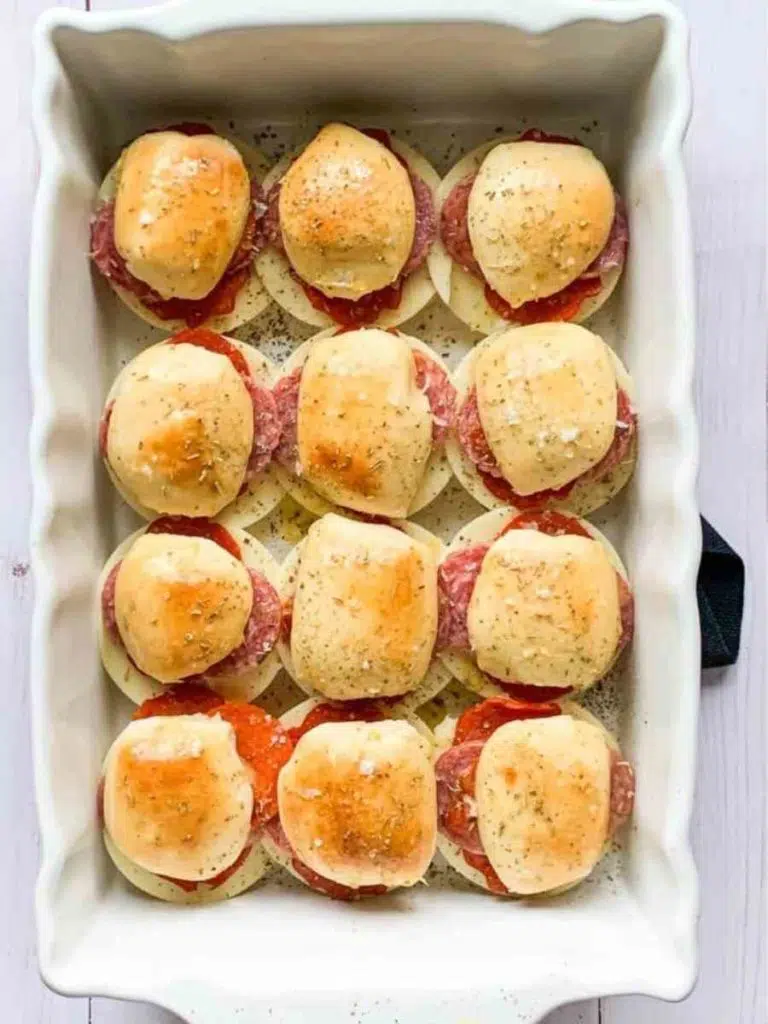 White baking dish filled with Italian sliders.