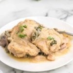 Crockpot creamy smothered chicken on a white plate.