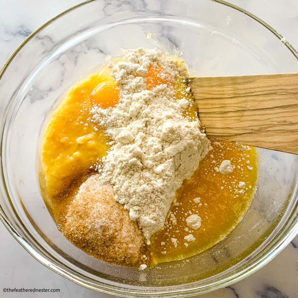 Combining baking mix, eggs and sugar in a glass mixing bowl.