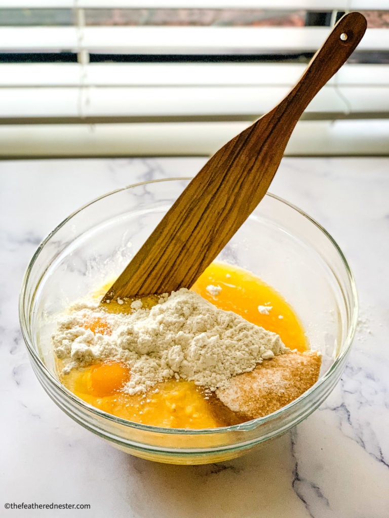 Mixing ingredients in a bowl for cornbread without cornmeal.