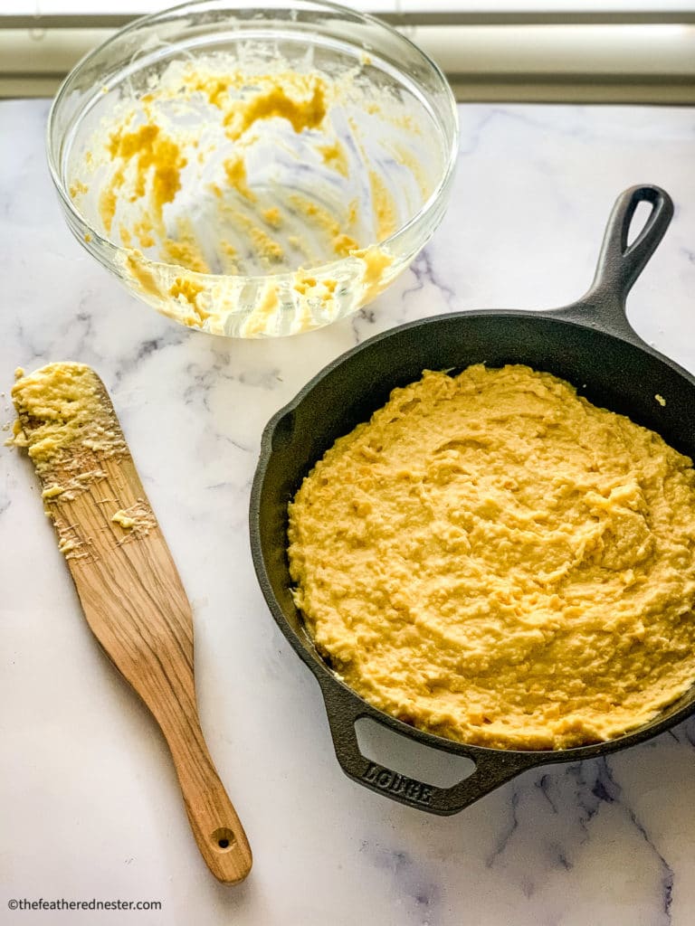 Unbaked Bisquick cornbread batter in a cast iron skillet.