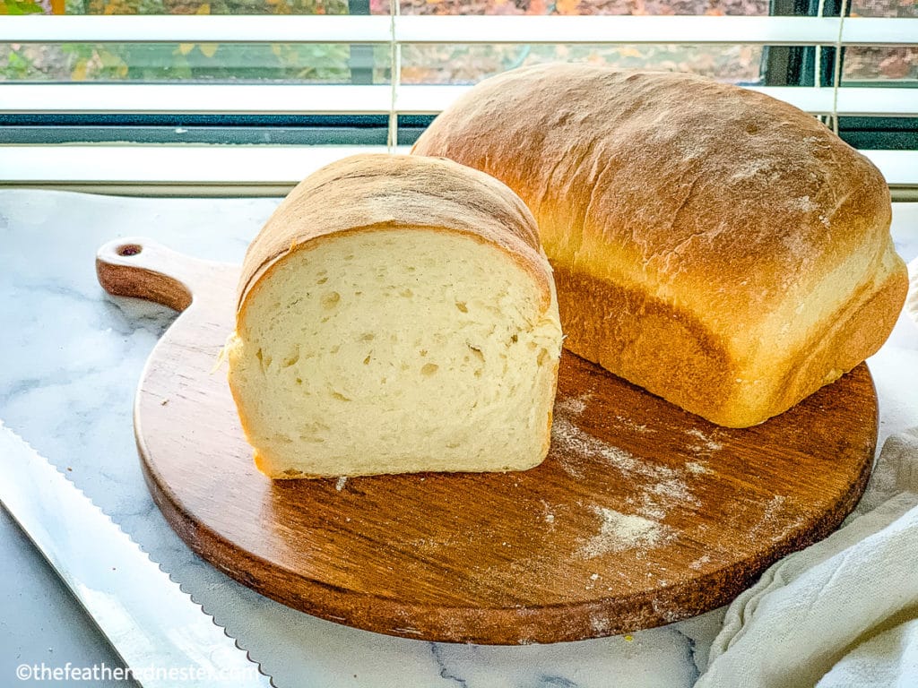 fresh sourdough sandwich bread on top of a wooden board.