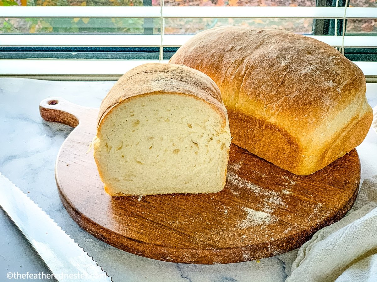 fresh sourdough sandwich bread on top of a wooden board.