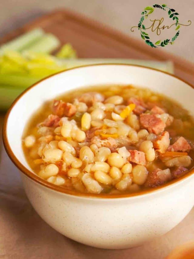 a white bowl of instant pot lima beans and ham ready to serve.