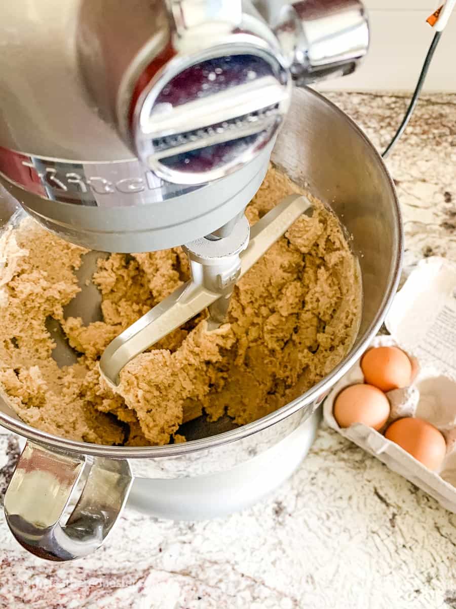 silver Kitchen Aid stand mixer filled with spring sugar cookie dough