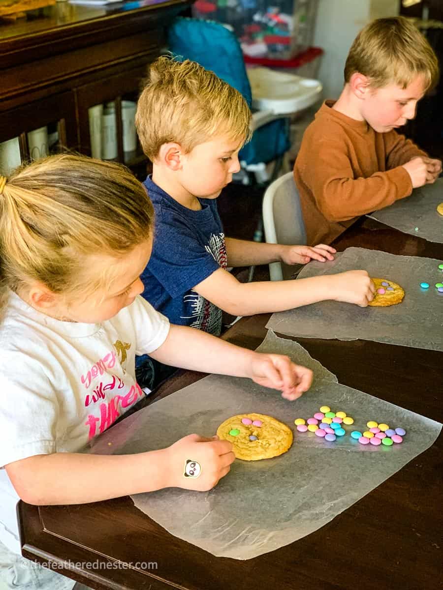 kids making spring sugar cookies with M&Ms 