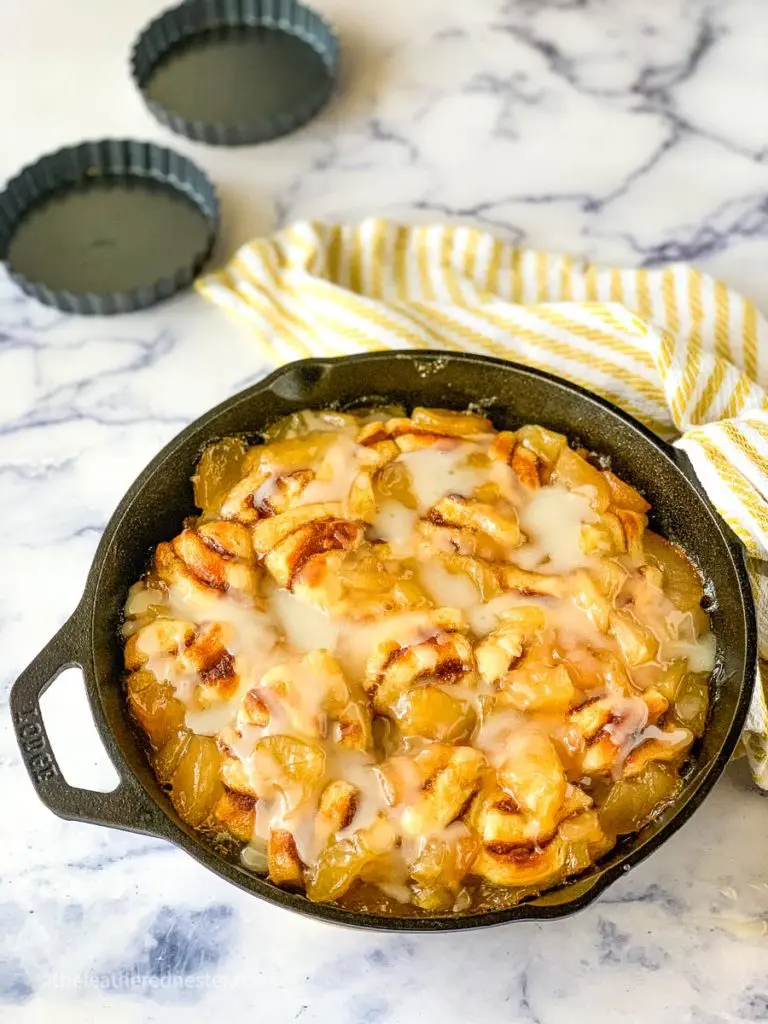 a skilled of freshly baked and iced cinnamon roll apple bake casserole ready to serve