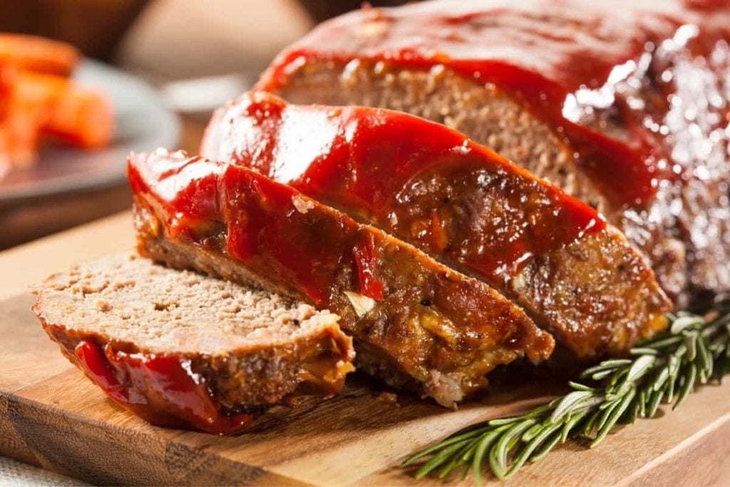 Sliced turkey meatloaf laid out on a cutting board.