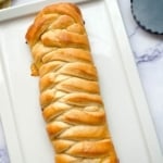 lemon braided bread loaf on a white platter.