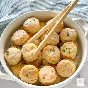 white serving bowl of mini biscuit appetizers.