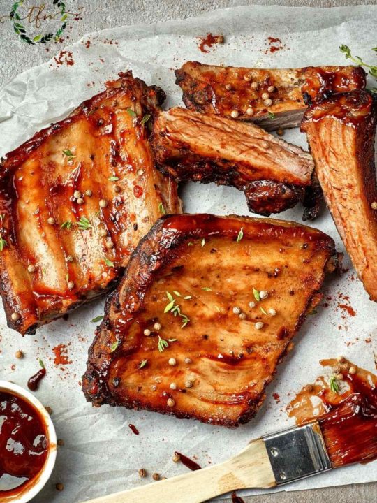 Cut baby back ribs ready to serve with a pastry brush of bbq sauce