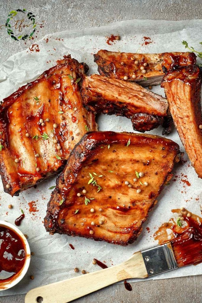 Cut baby back ribs ready to serve with a pastry brush of bbq sauce